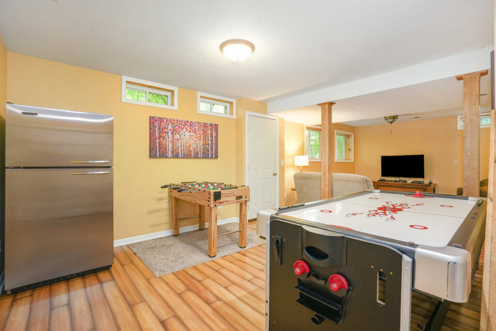 Basement game room with air hockey and foosball tables