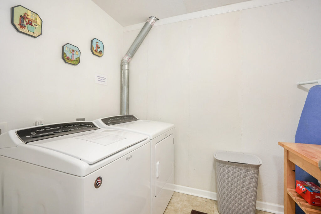 Laundry room with washer, dryer, and ironing board