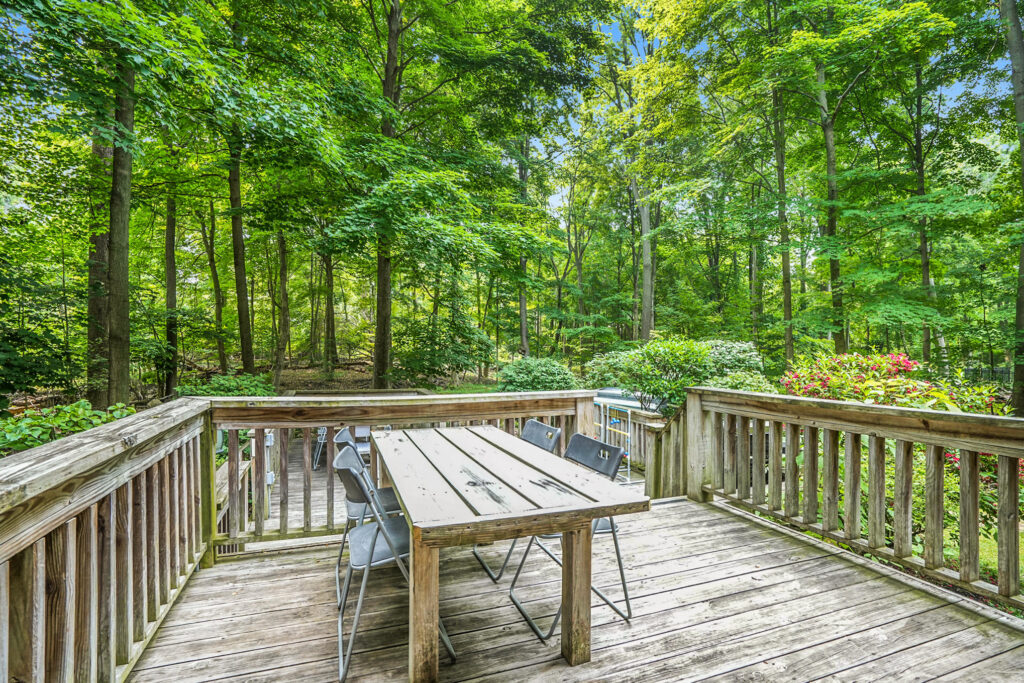 Wooden deck with table overlooking forest view