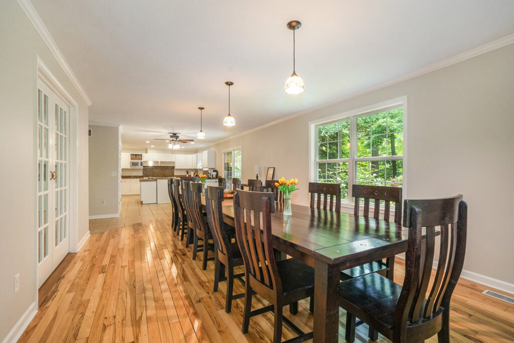 Spacious dining room with wooden table and chairs