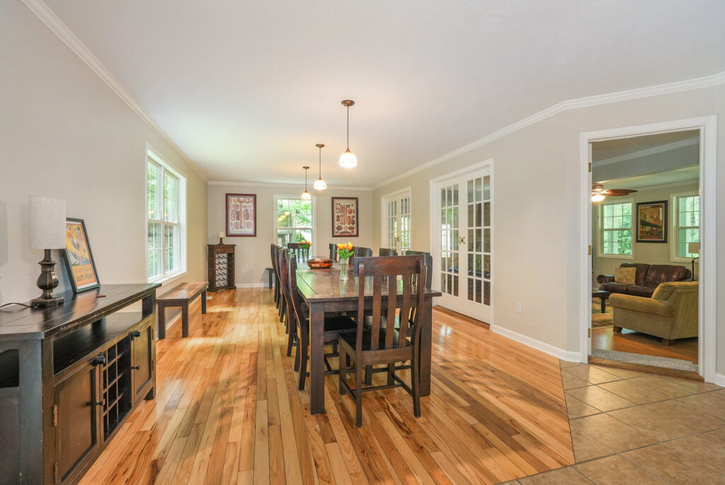 Spacious dining room with wooden table and chairs