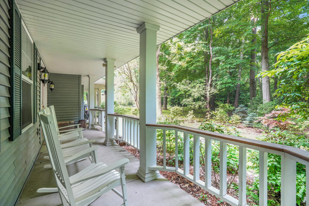 Front porch with rocking chairs and forest view