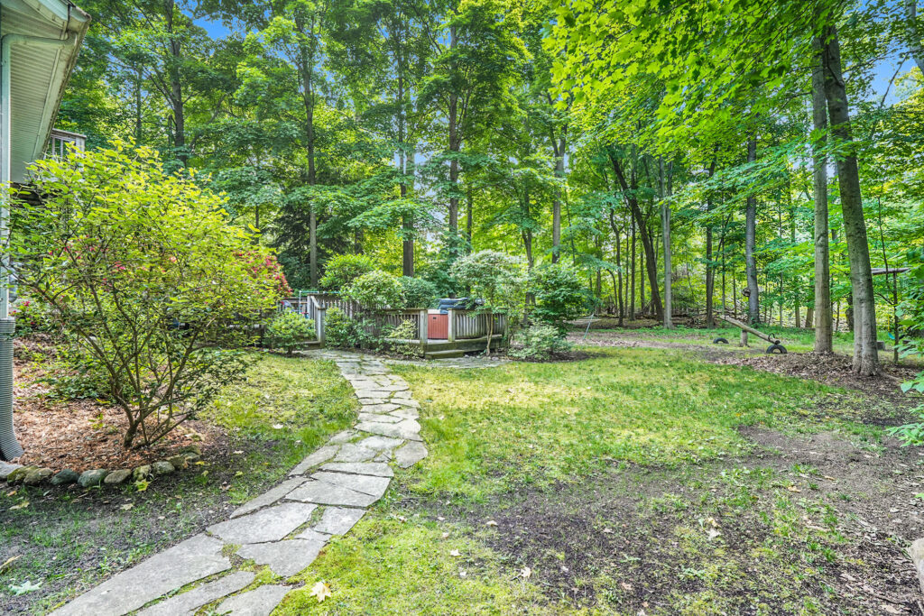 Shaded backyard with stone path and trees
