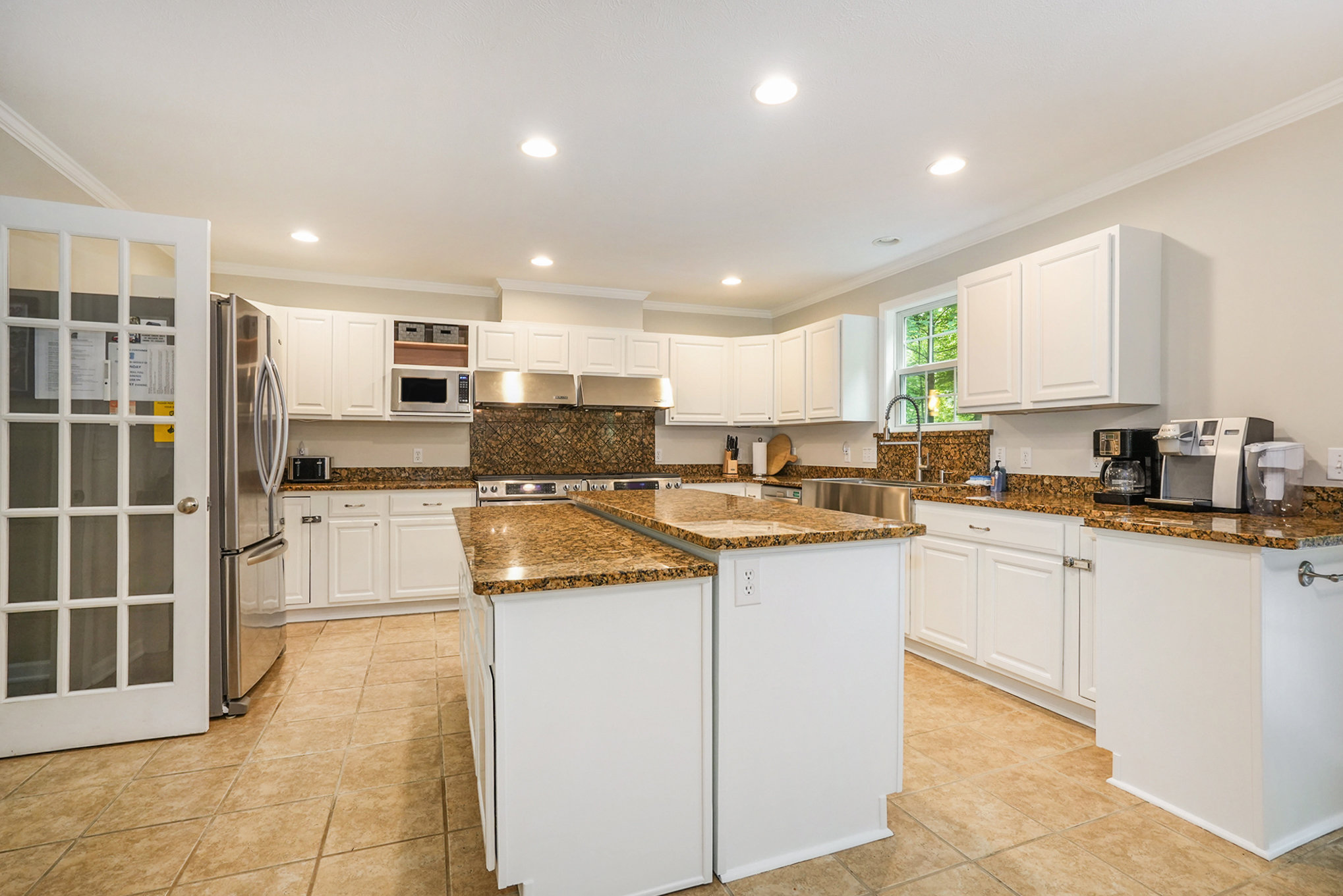 Modern kitchen with white cabinets and granite countertops