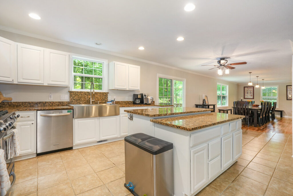 Spacious kitchen with granite countertops and dining area