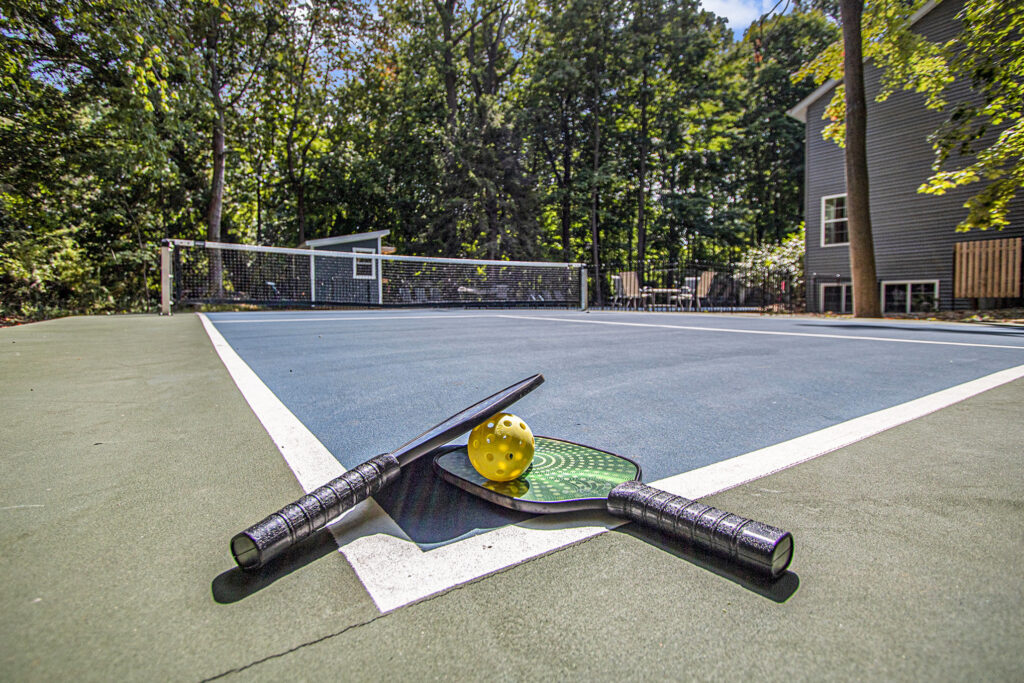 Pickleball paddles and ball on outdoor court