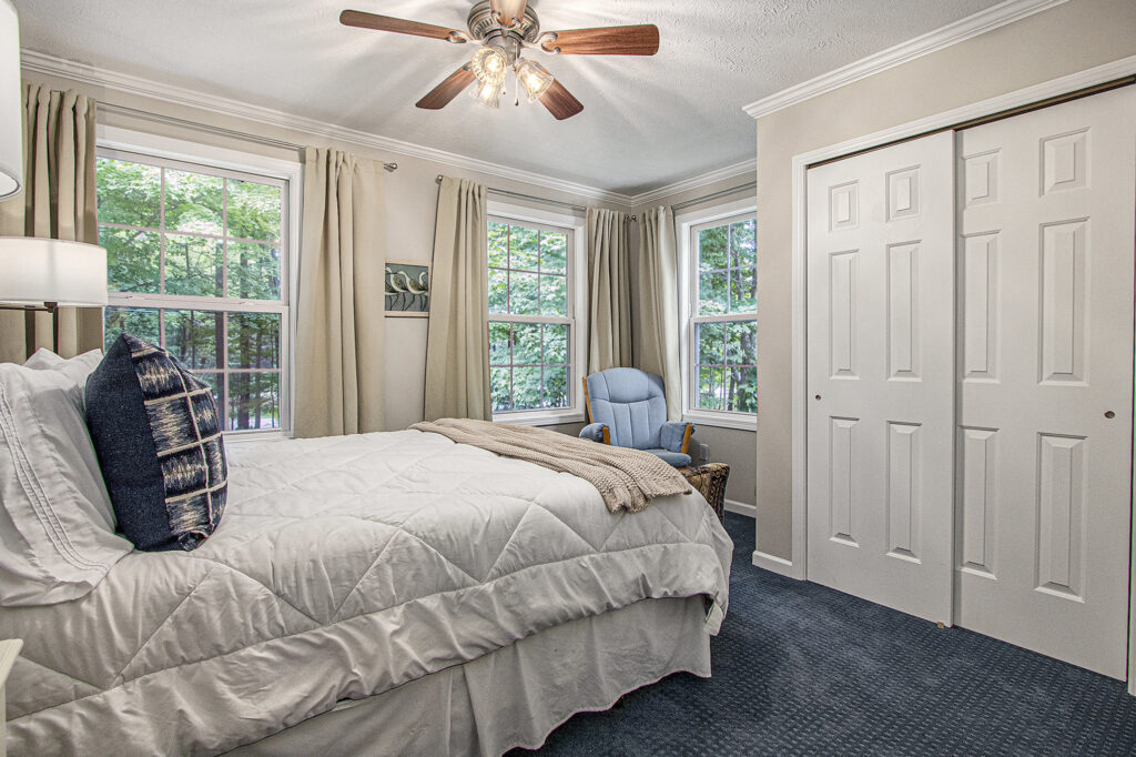 Cozy bedroom with bed and windows