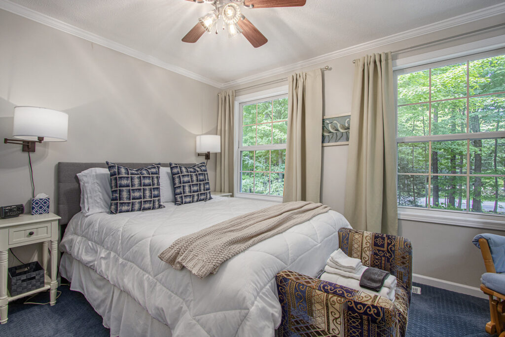 Cozy bedroom with large windows and natural light