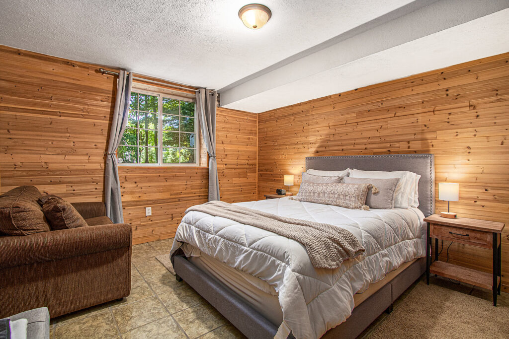 Cozy bedroom with wood walls and large bed