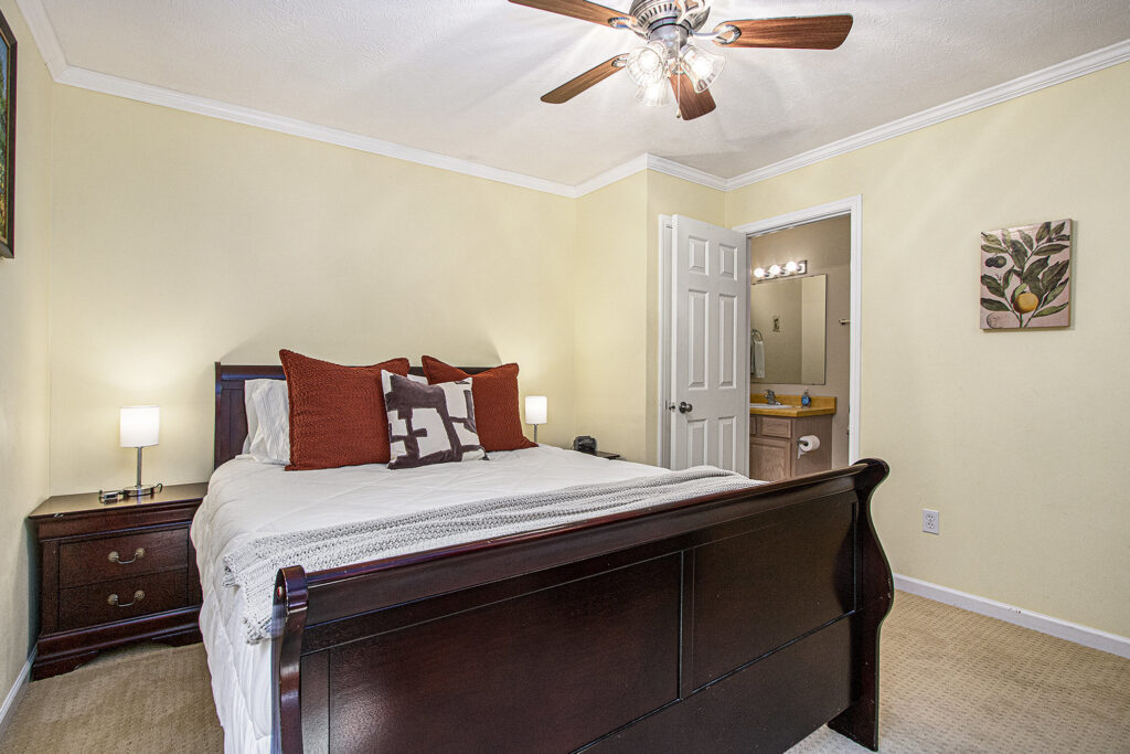 Cozy bedroom with wooden bed and bathroom