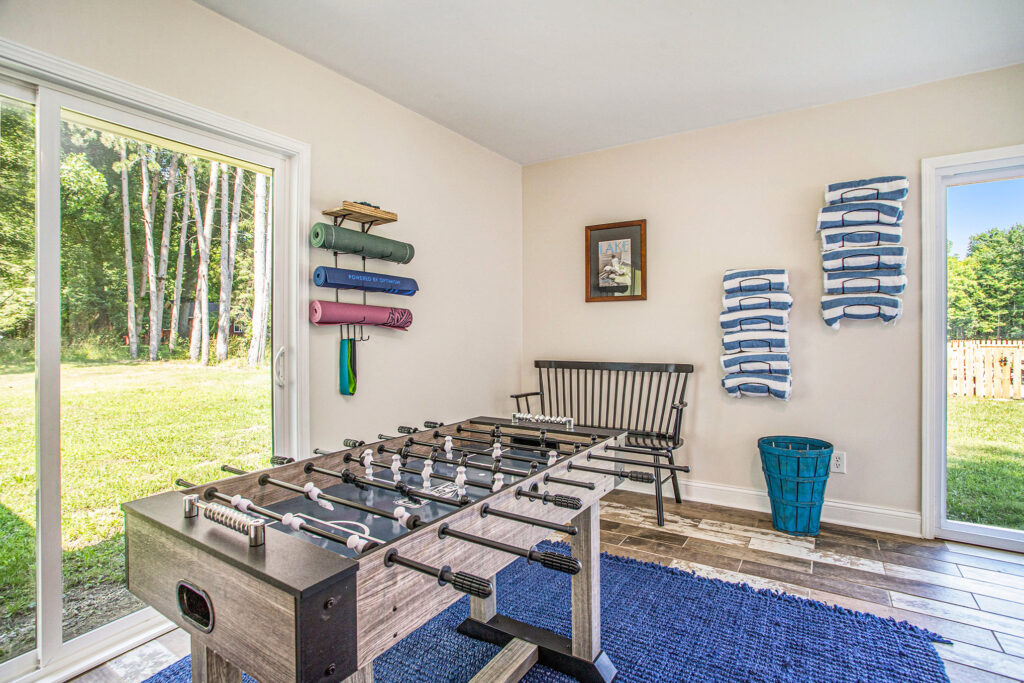 Bright game room with foosball table and yoga mats