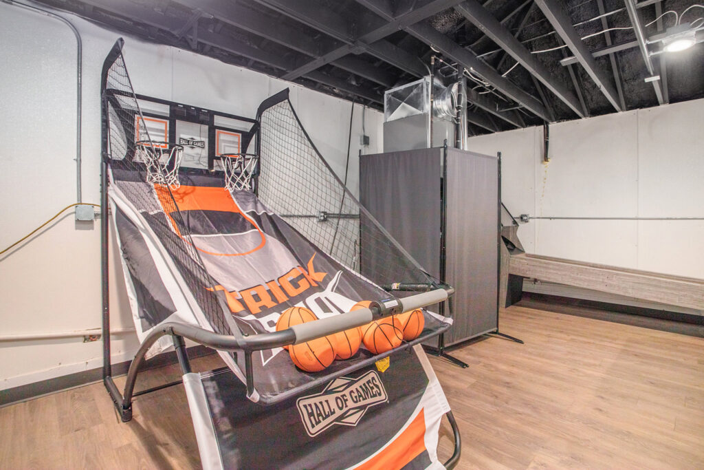 Indoor basketball arcade game in recreation room