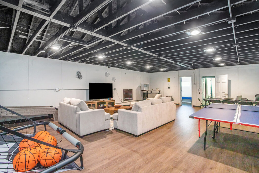 Spacious game room with couches and ping pong table