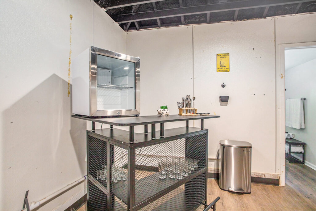 Modern home bar setup with mini fridge