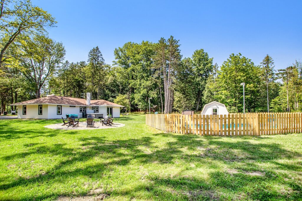 Cozy countryside house with fenced yard and trees