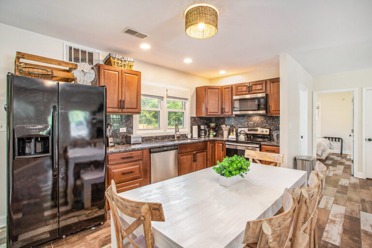 Modern kitchen with wooden cabinets and dining table