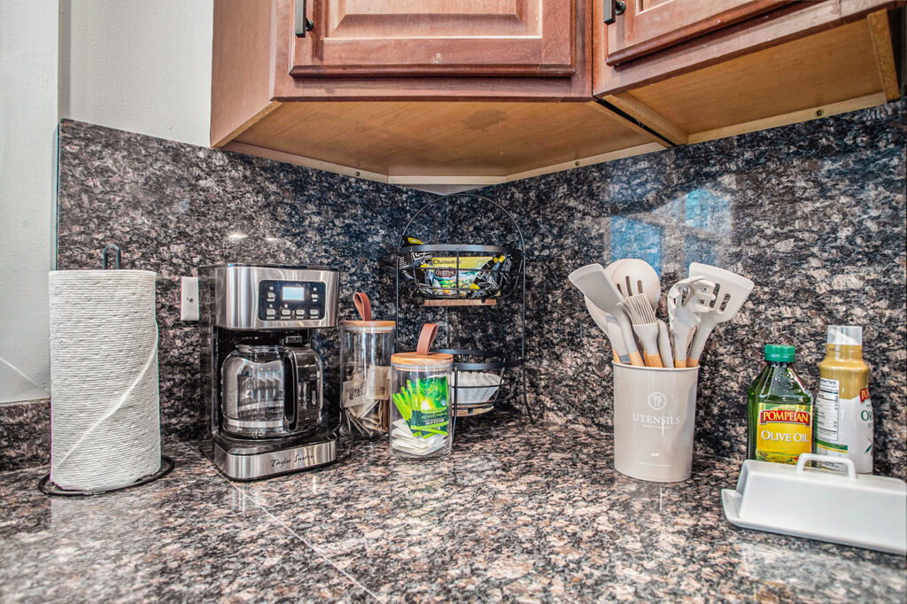 Granite kitchen countertop with coffee maker and utensils