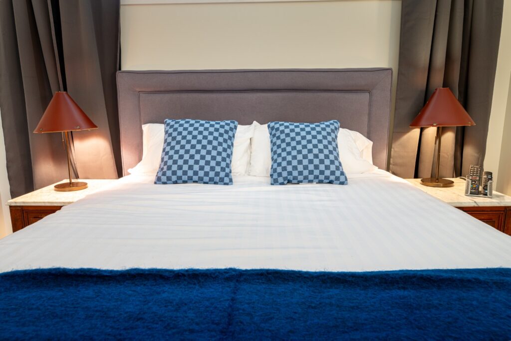 Modern bedroom with blue pillows and lamps