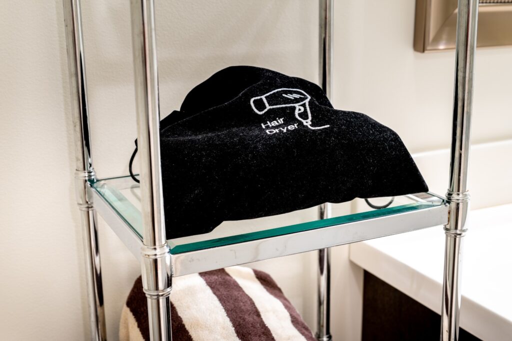 Hair dryer bag on bathroom shelf