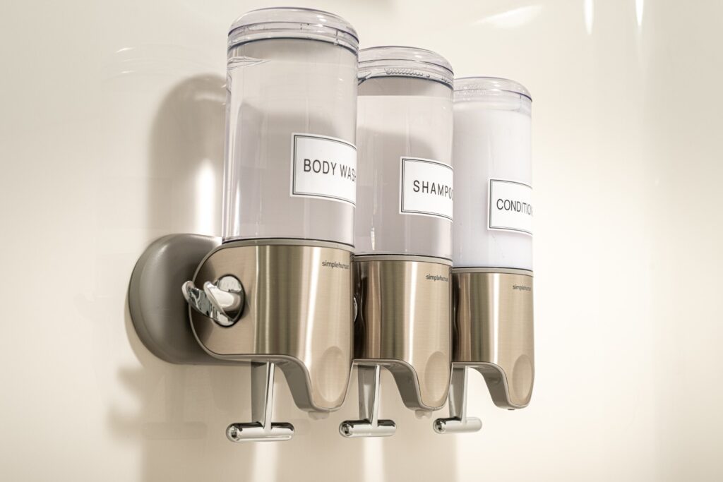 Wall-mounted dispensers for body wash, shampoo, conditioner