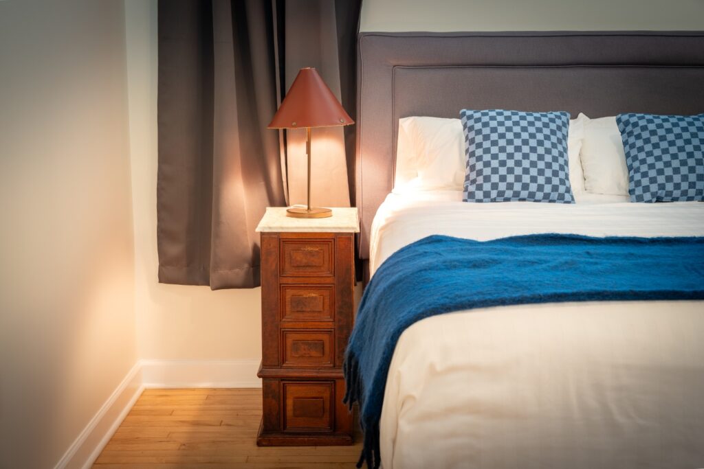 Cozy bedroom with lamp and blue bedding