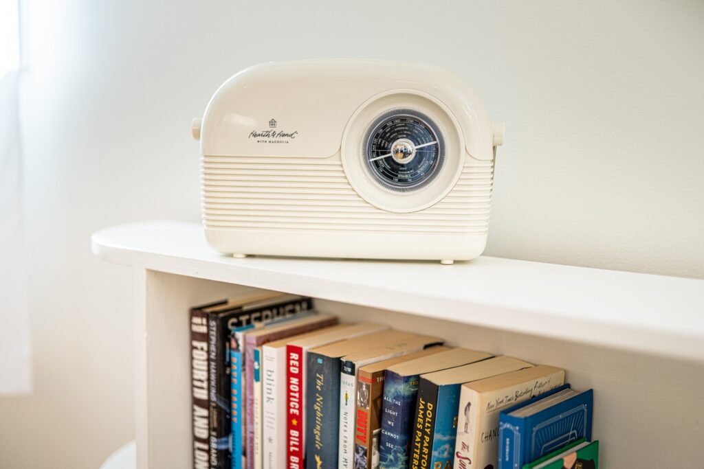 Vintage radio on bookshelf with books
