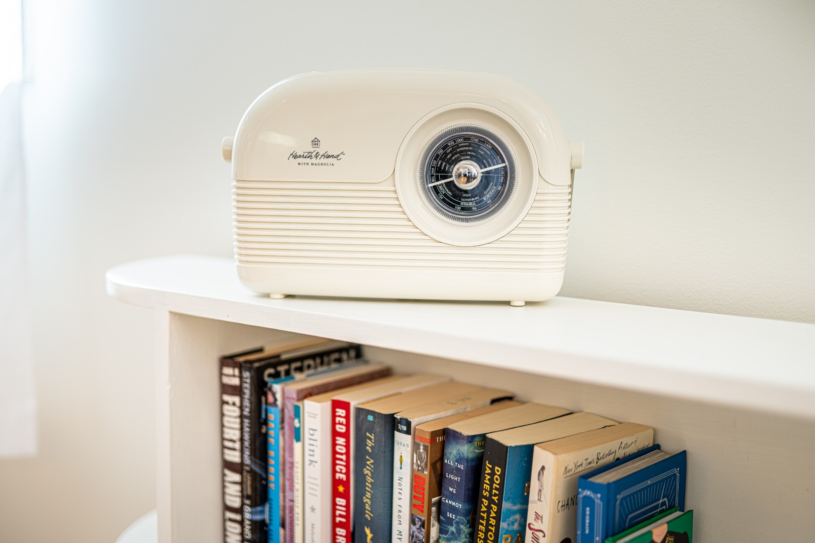 Vintage radio on bookshelf with books