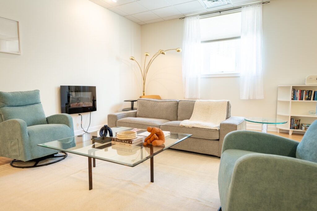 Modern cozy living room with sofas and armchairs