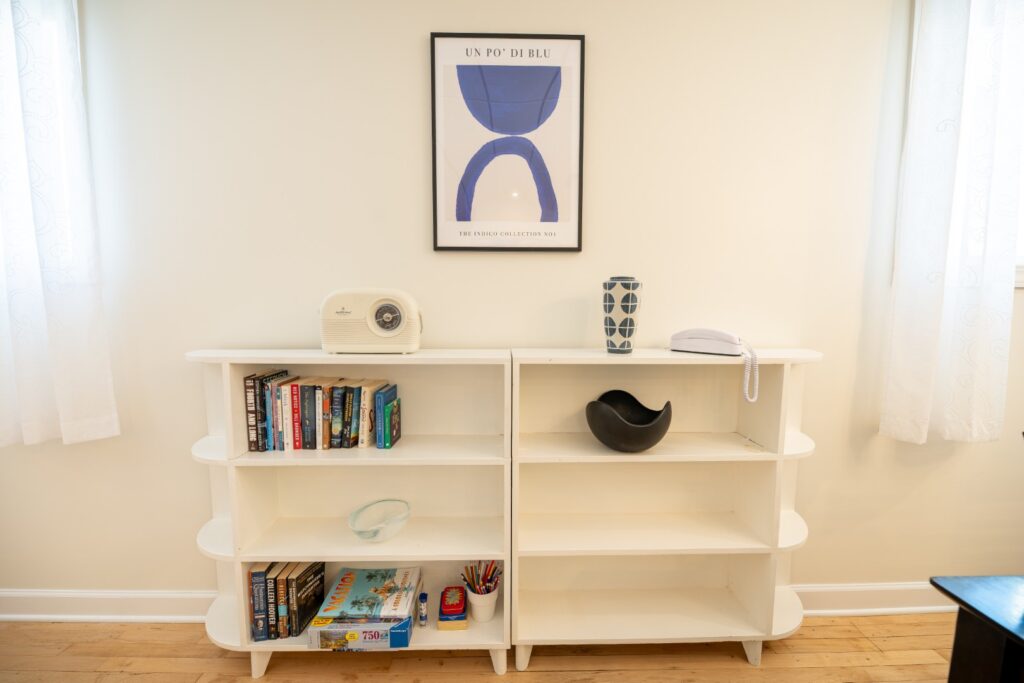 White bookshelf with books and decorative items