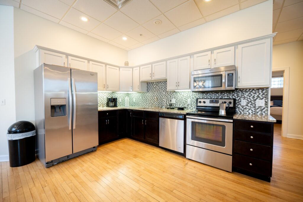 Modern kitchen with stainless steel appliances and wood floor