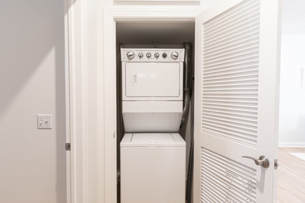 Stacked washer and dryer in closet