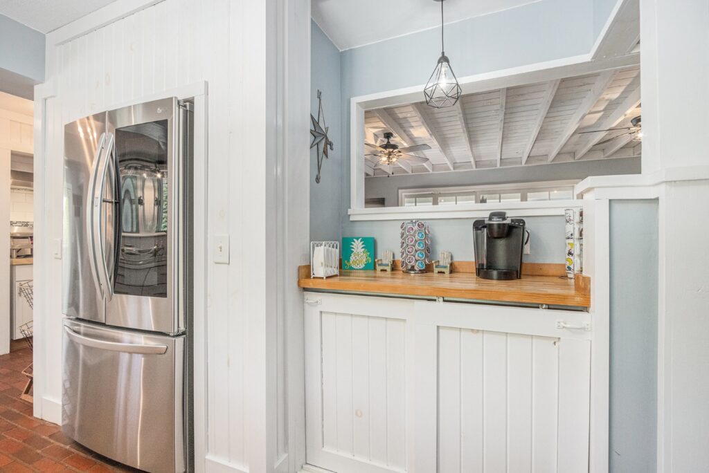 Modern kitchen with stainless fridge and coffee station