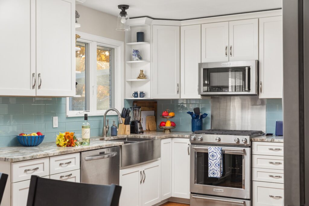 Modern white kitchen with stainless steel appliances
