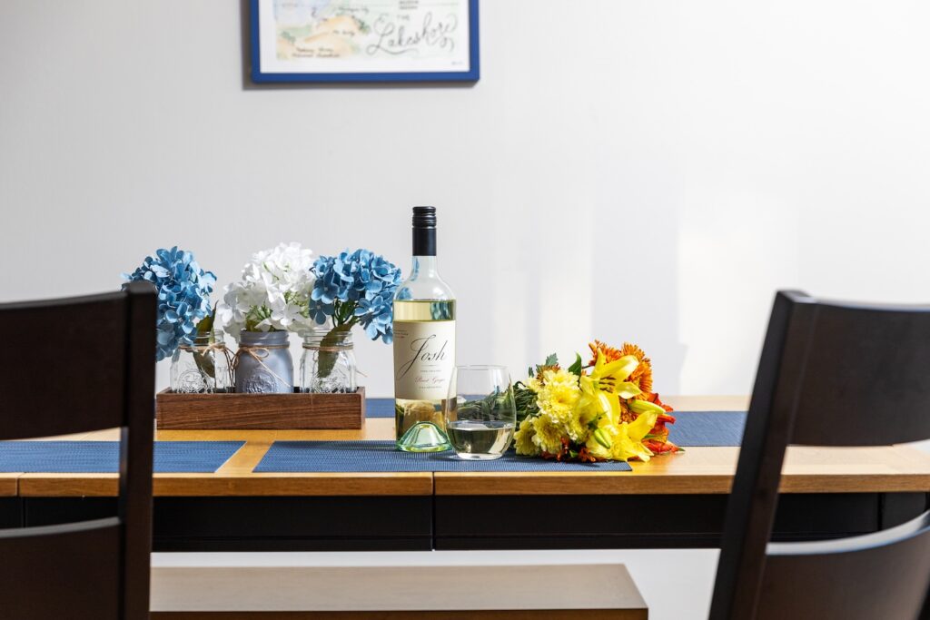 Wine bottle and flowers on dining table