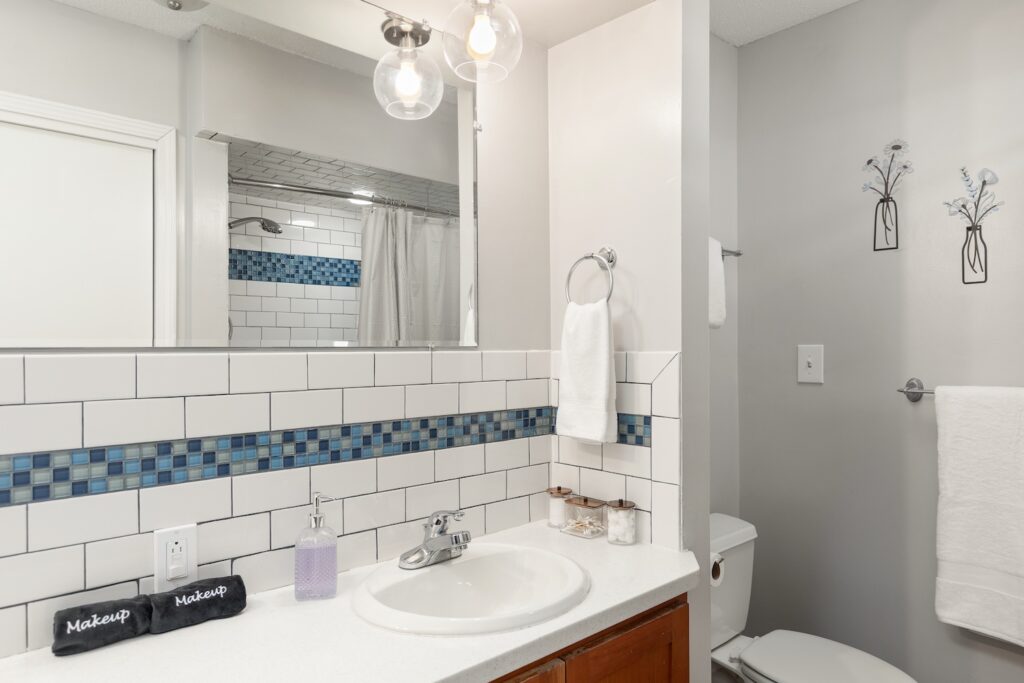 Modern bathroom with white and blue tile accents