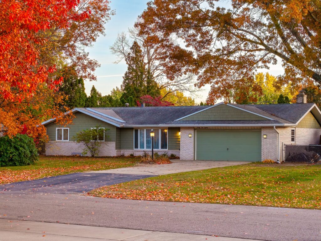 Suburban house with fall foliage and driveway