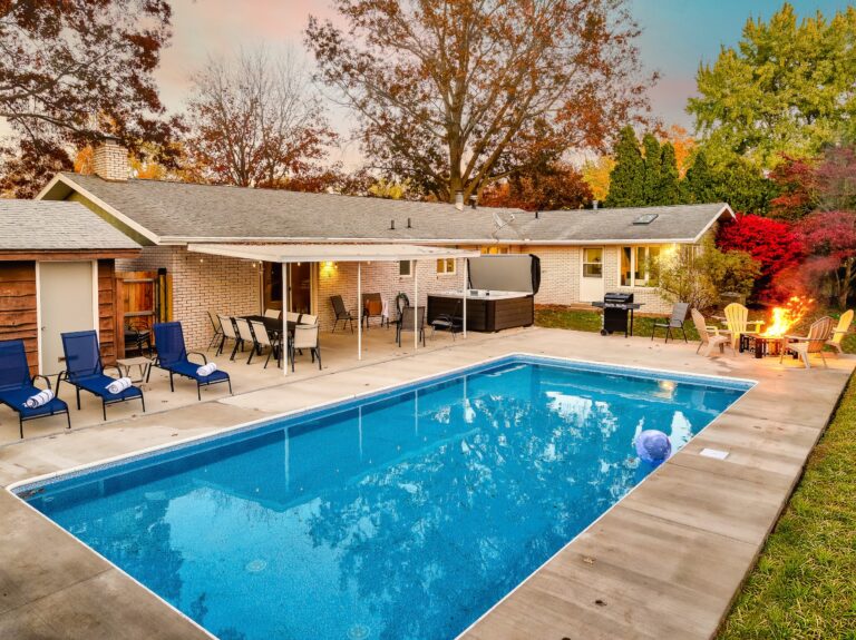 Backyard with pool, patio, and fire pit area