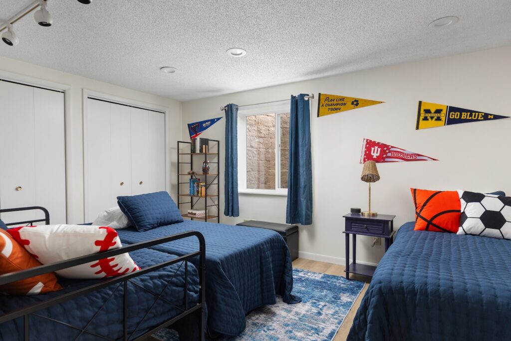 Sports-themed bedroom with two twin beds