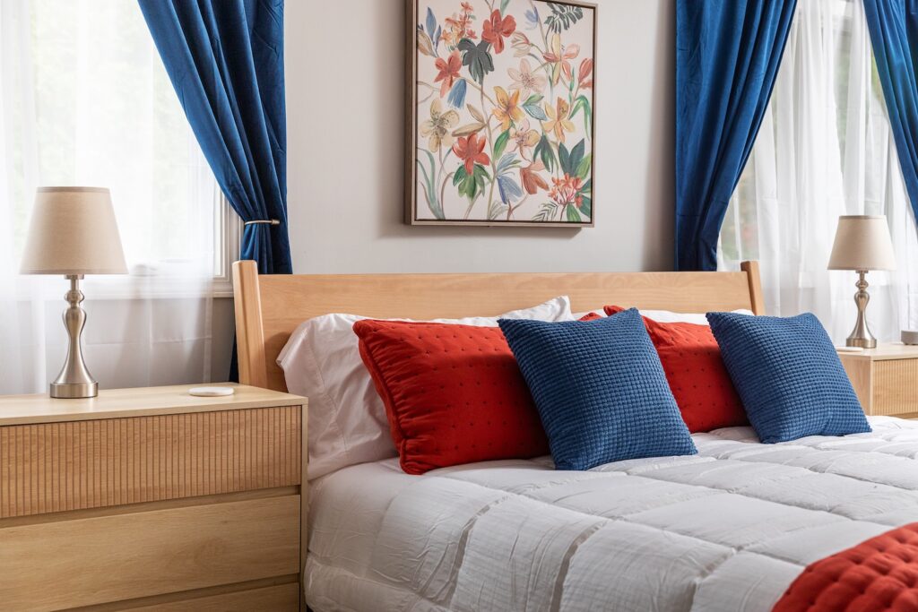 Cozy bedroom with blue and red pillows