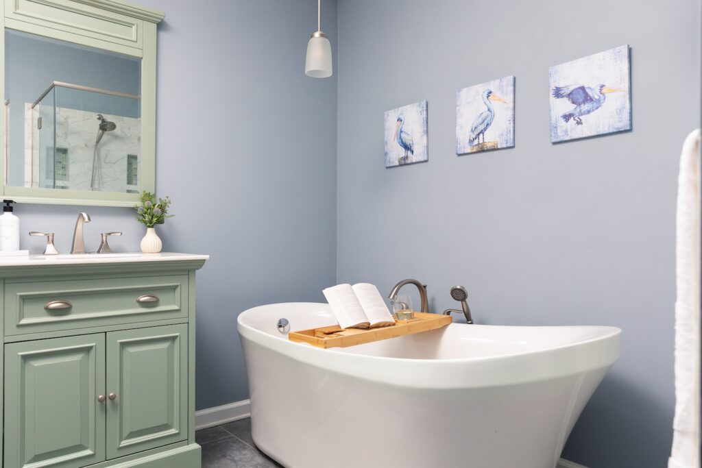 Modern bathroom with bathtub and mint vanity