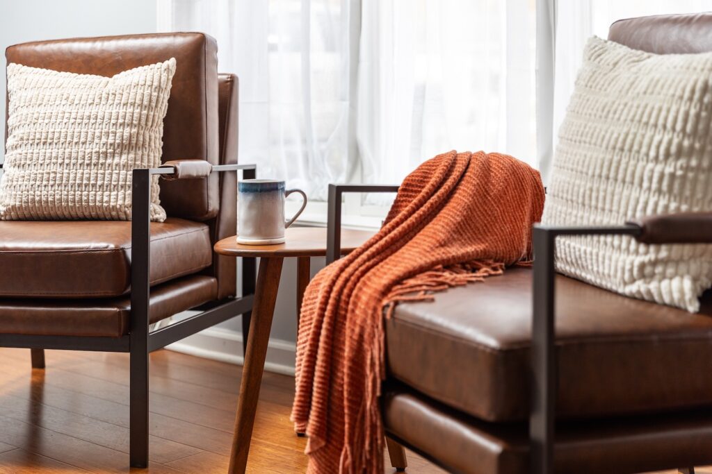 Cozy living room with leather chairs and blanket