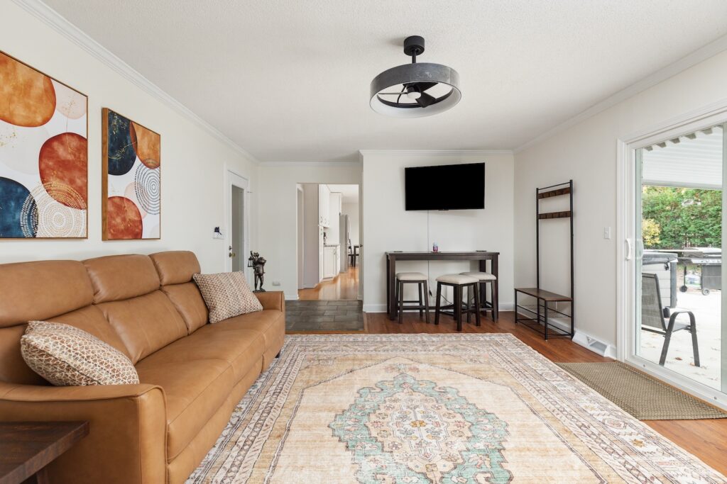 Modern living room with tan sofa and rug