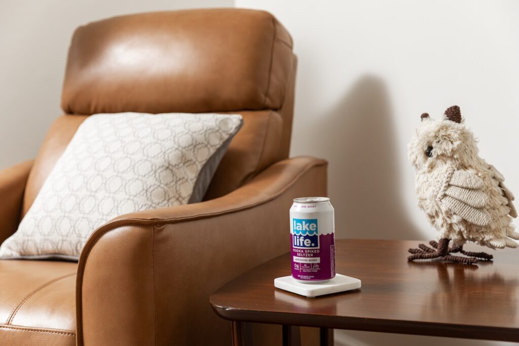 Seltzer can on table beside leather chair