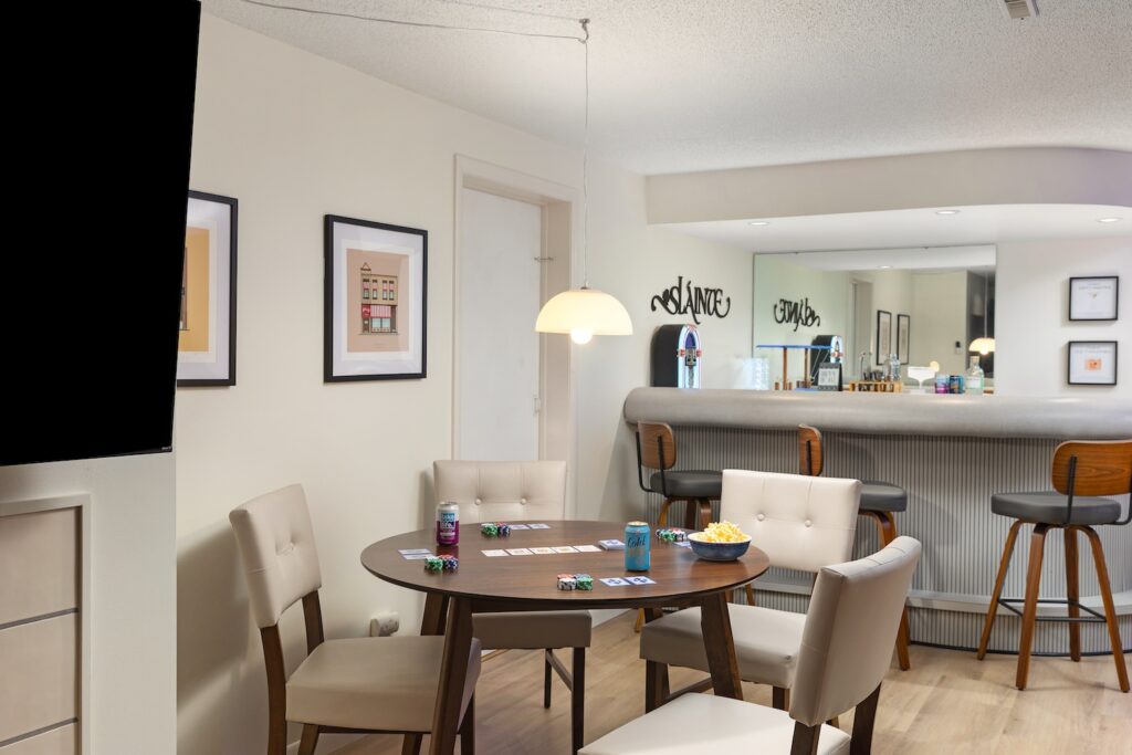 Modern game room with table and bar seating