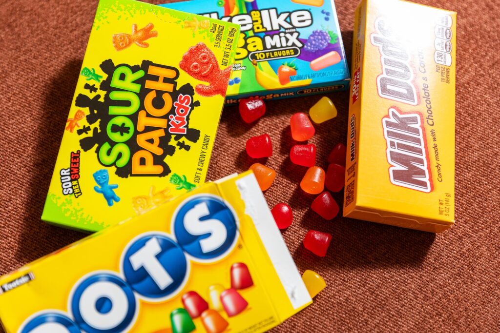 Assorted colorful candy boxes on fabric surface